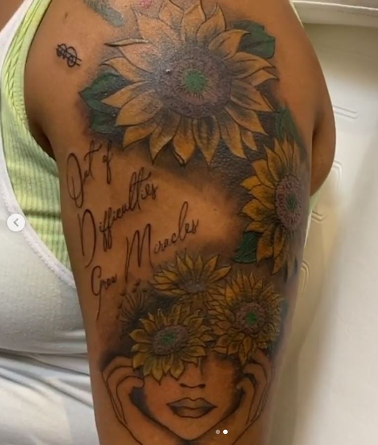 Screenshot of sunflower tattoos on person's shoulder and arm