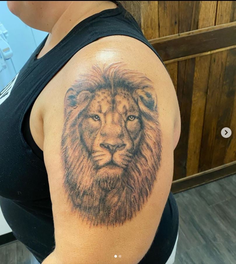 Screenshot of lion tattoo on woman's shoulder