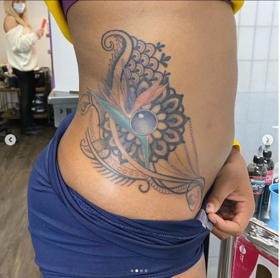 Screenshot of peacock feather tattoo on someone's side